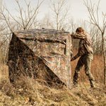 A man setting up the blind in the field